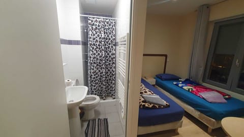 Economy Room | Bathroom | Shower, free toiletries, slippers, towels