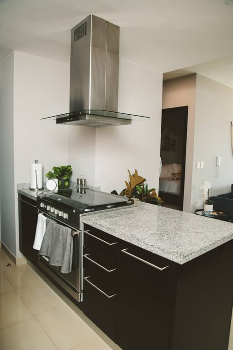 Discover the epitome of functionality in our fully equipped kitchen. This open-concept space offers a seamless view into the dining room, promoting a sense of togetherness. Modern appliances stand ready to assist your culinary endeavors, ensuring a seamless cooking experience