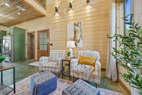 Discover the perfect living-room cozy conversation spot – two cozy armchairs with ottomans.