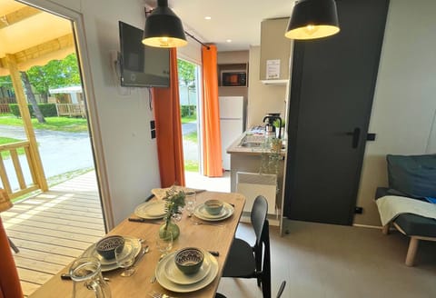 This inviting dining space, with doors that open to the deck, blends indoor comfort with an outdoor ambiance for memorable meals.