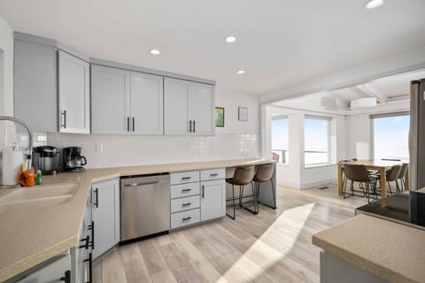 The open-layout kitchen features luxurious stainless steel appliances, making it a dream for cooking and gathering with loved ones.