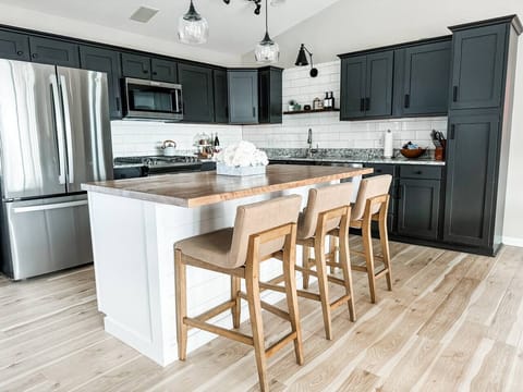 Fully stocked kitchen equipped with stainless steel appliances, dishwasher, crockpot, waffle iron, griddle and more!