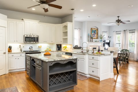 Modern kitchen is fully equipped and features stainless steel appliances.
