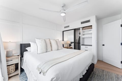 The first bedroom includes a king-size bed with fresh, clean bedding.