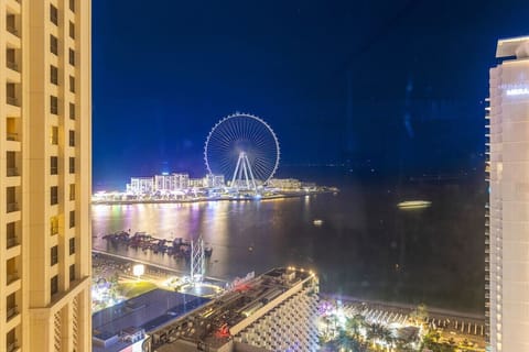 Stunning View: Breathtaking nighttime skyline with Dubai's iconic Ferris wheel shining bright!