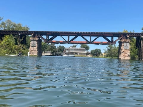 Train trestle bridge is no longer active.  Fun to jump off or watch people come by boat for a quick jump.