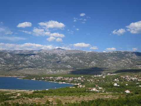 Cloud, Water, Sky, Mountain, Plant, Lake, Natural Landscape, Highland, Cumulus, Tree