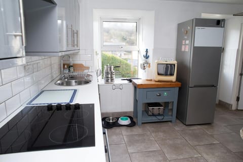 Kitchen with fridge freezer, microwave and toaster