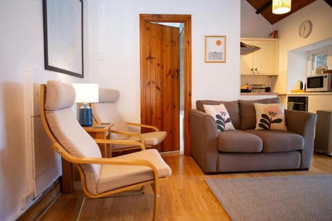 Lounge with armchairs, sofa, view of kitchen