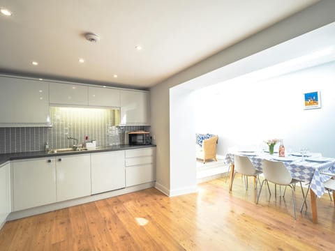 Wooden floors leading from kitchen to dining area