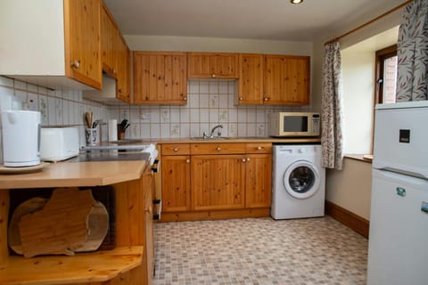 Kitchen with fridge freezer, washing machine, cooker