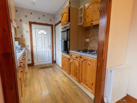 Cabinetry, Furniture, Countertop, Drawer, Wood, Kitchen, Wood Stain, Flooring, Floor, Chair