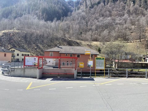 Mountain, Building, Tree, Asphalt, Vehicle, Road Surface, Sky, Landscape, Road