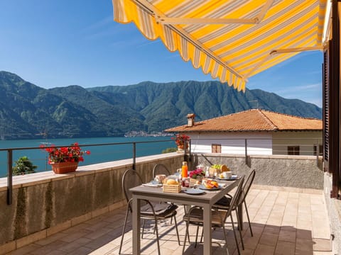 Table, Sky, Property, Mountain, Furniture, Building, Flowerpot, Water, Azure, Outdoor Furniture