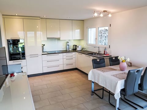 Kitchen, Furniture, Countertop, Kitchen Appliance, Flooring, Interior Design, Cabinetry, Floor, Major Appliance, Lighting