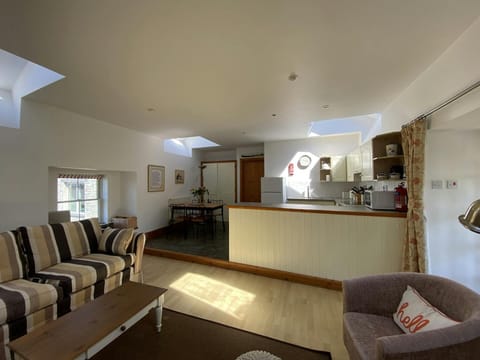 Living area with sofa, coffee table, dining table and chairs