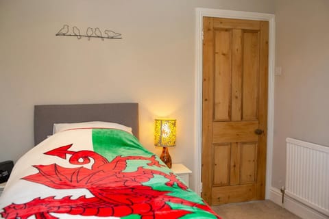 Single bed with bedside table and lamp