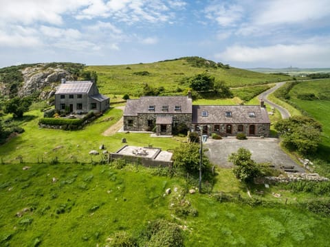 Aerial view of Y Bwthyn and surrounding countryside, sea in the distance