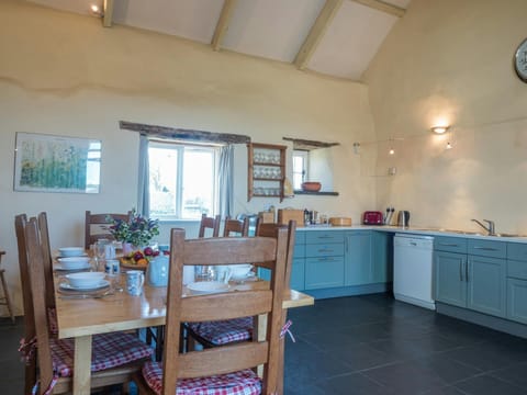 Kitchen and dining area with table and chairs