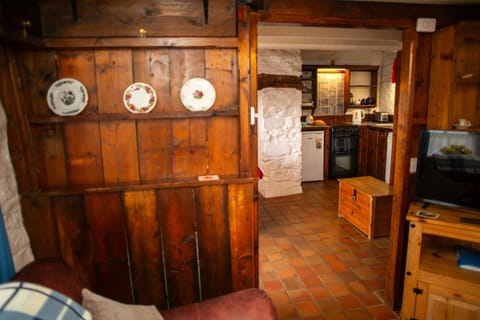 Living area and kitchen with wood partition walls