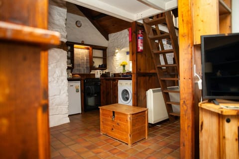 Living area with wooden steps to bedroom area