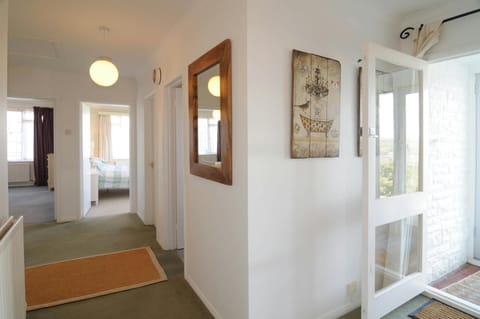 Hallway with rug, mirror