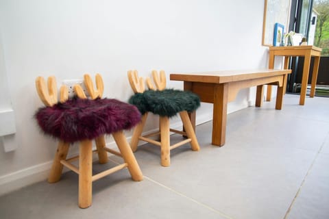 Two wooden stools with fleece cushions and wooden bench