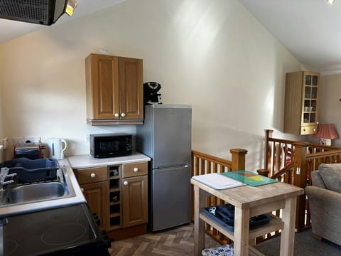 Microwave, cabinets, sink, table