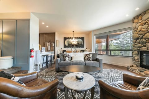 The living room is set up for all your relaxing and entertaining needs with two leather chairs, a plush 3-person sofa, a coffee table, a 65” Samsung Smart TV.