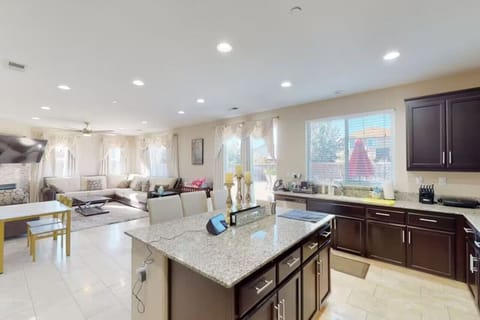 Large kitchen with island and stainless appliances