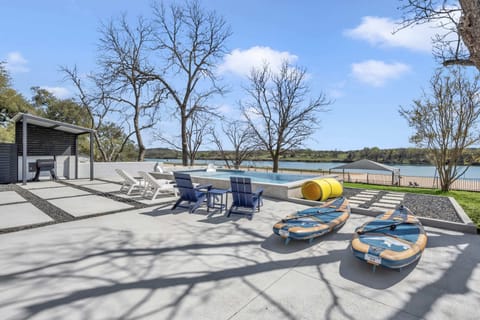 Lounging chairs, 2 stand up paddleboards, and a floating water pad