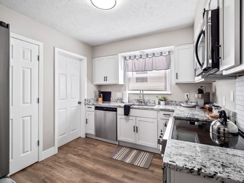 Step into this dreamy kitchen where the white cabinets shine as bright as your culinary creations! 🍽️ #KitchenGoals