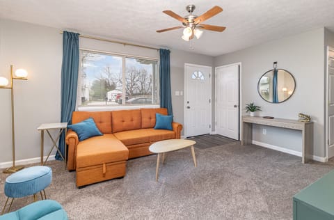 Living room with a 55” smart TV. you can stream on your streaming services.