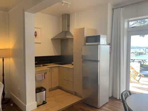 Waterfront Apartment | Private kitchenette | Fridge, electric kettle