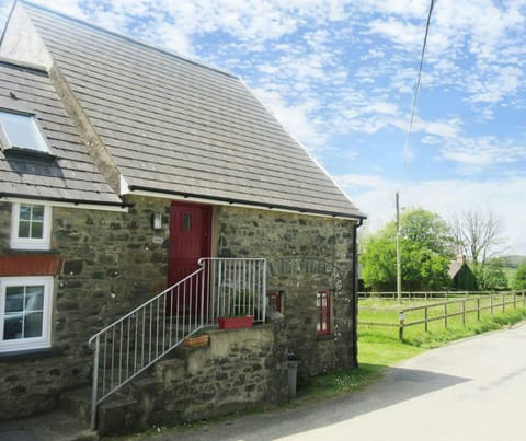 Exterior of The Steps cottage with stairs and handrail leading up to front door