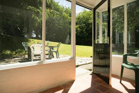 Sunroom opening out onto the garden at Garden Cottage