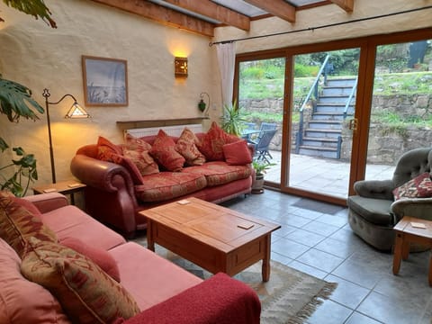 Second lounge, 2x seater sofas , armchair , coffee table, patio doors leading to outside