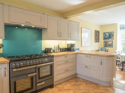 Kitchen with double cooker, kettle, toaster, view of dining area