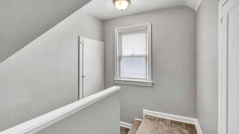 Stairway leading to the bedrooms—elegant steps that guide you to a restful retreat. A simple transition from the main living areas to where comfort and relaxation await at the top.