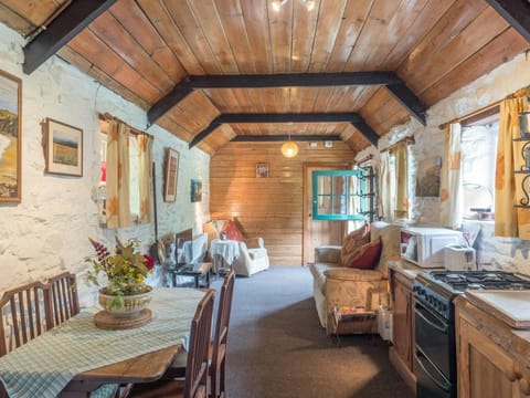 Living area with dining table and chairs, cooker, seating area