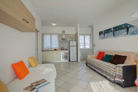 Family Apartment, 1 Bedroom, Lakeside (Casa al Cor - Bike 1) | Living area | 21-inch flat-screen TV with satellite channels