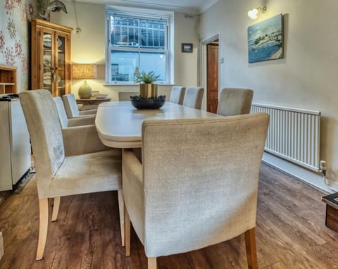 Dining room with table and chairs and corner storage cupboard