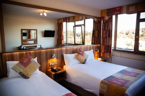 Standard Triple Room | Desk, laptop workspace, blackout drapes, iron/ironing board