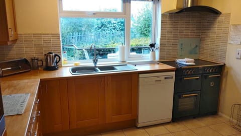 Spacious kitchen with dishwasher, electric part induction range cooker with extractor hood, built in microwave, fridge freezer, toaster