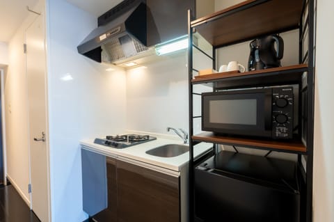 Apartment | Private kitchen | Mini-fridge, microwave, stovetop, cookware/dishes/utensils