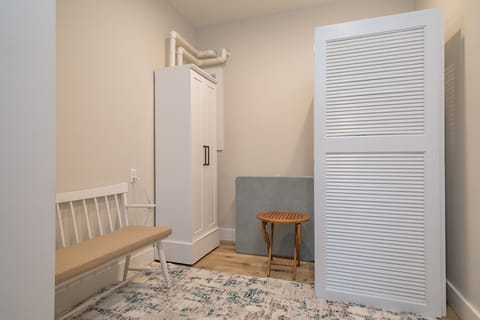 Main floor laundry room with stackable washer and dryer and on-demand water heater