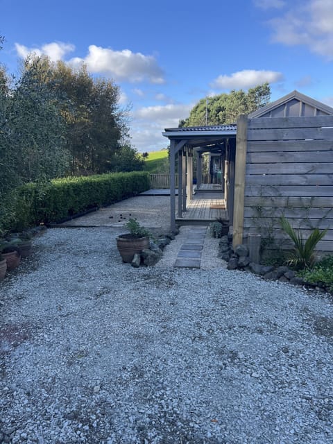 Patio: Evening view with lights on, from the car park.