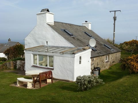 Tal y Gaer from the garden showing lawns and patio area with seating