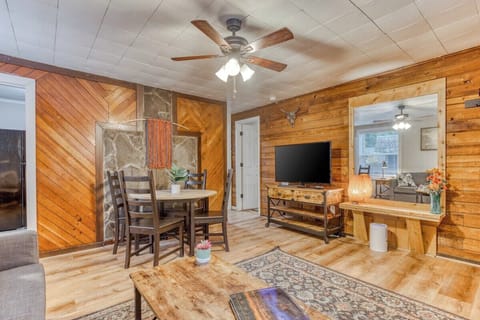 Step right in! See the open living and dining area with a big 55" TV, perfect for relaxing after your adventures. Book your cozy stay!