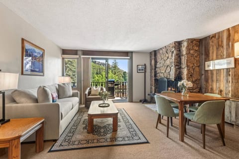 The living area offers a pull-out sofa bed for additional sleeping space, a dining table for 4, a wood burning fireplace and flat screen TV.